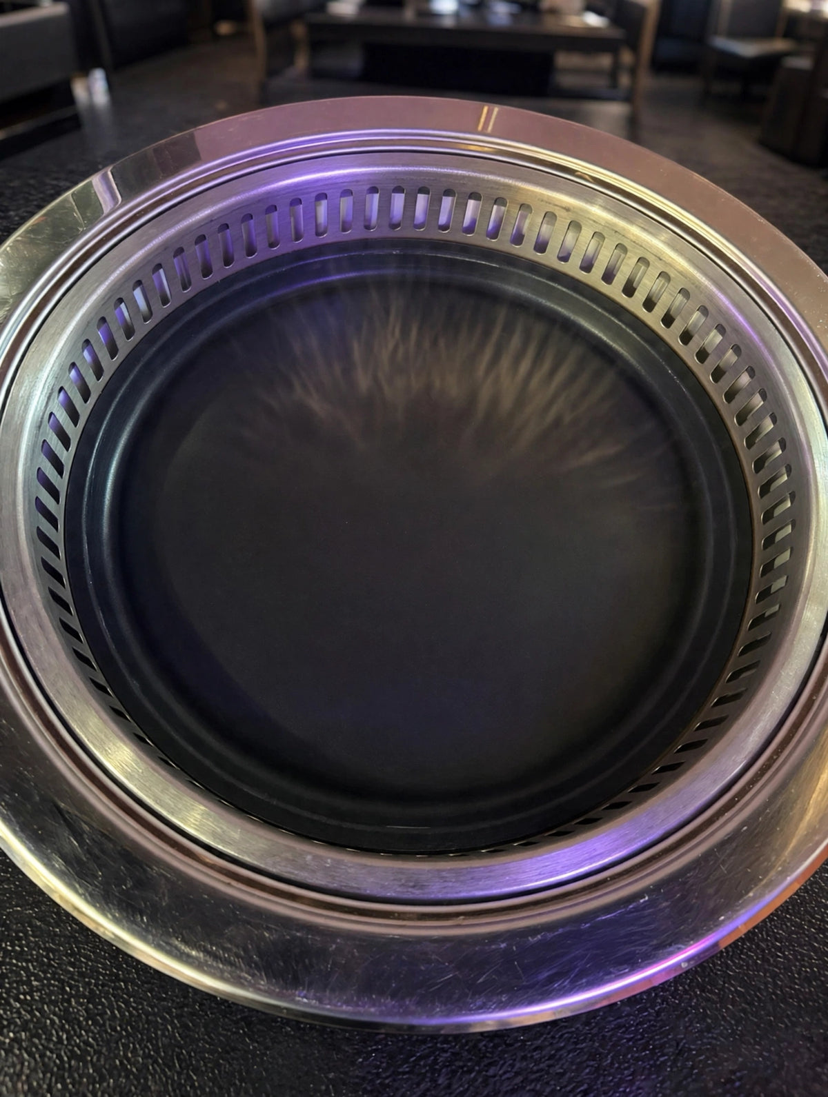 Flat Korean BBQ grill plate set in a restaurant table grill